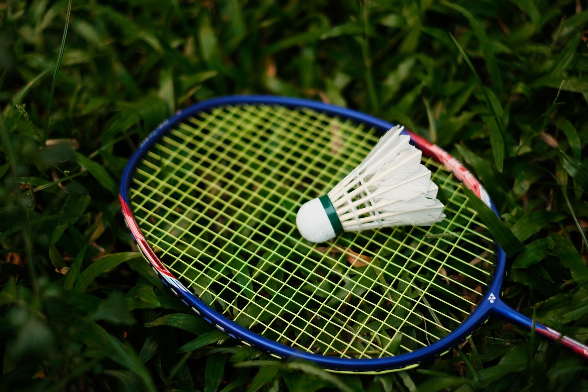 Badminton racket and shuttlecock on the court