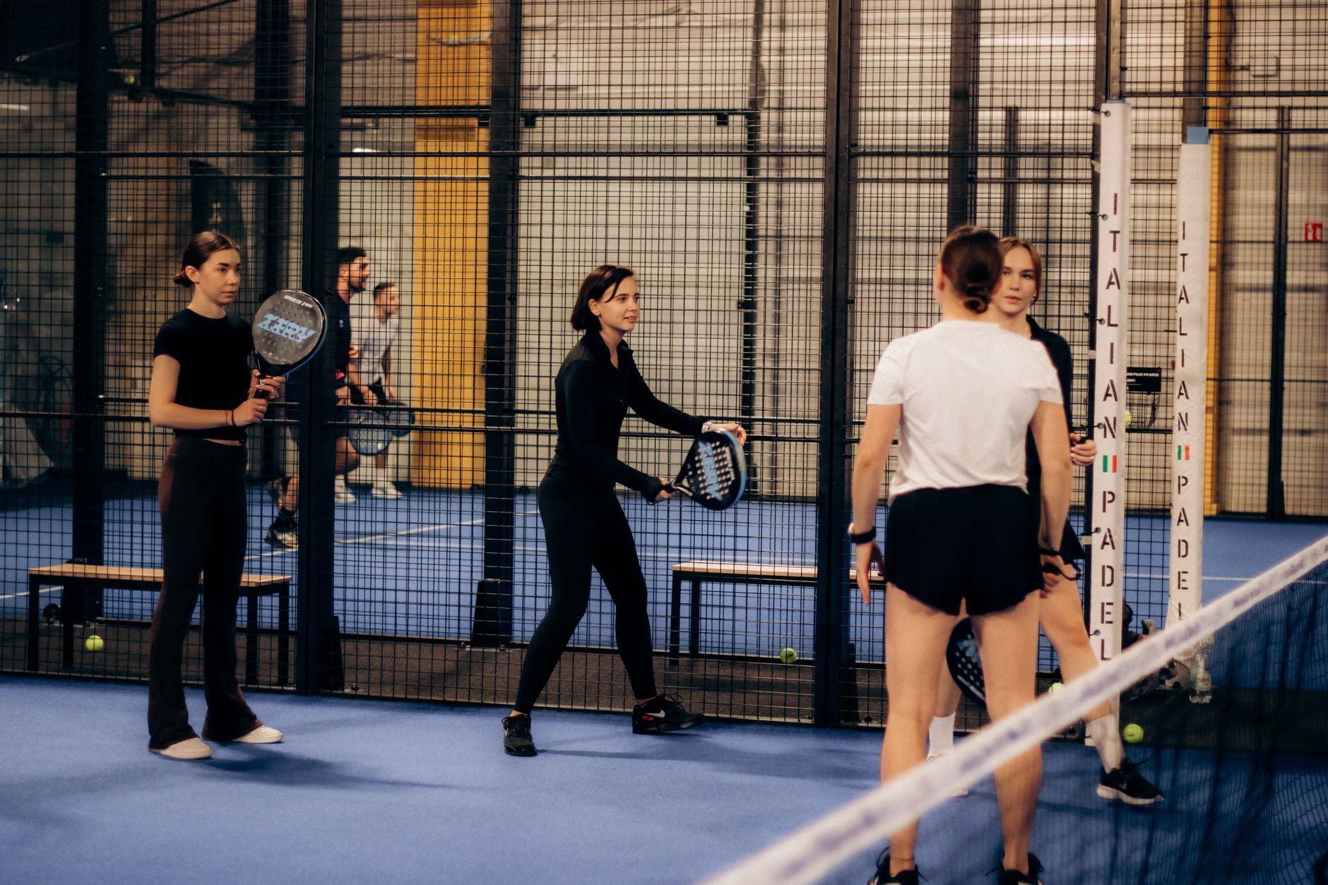 Players preparing for an indoor padel match