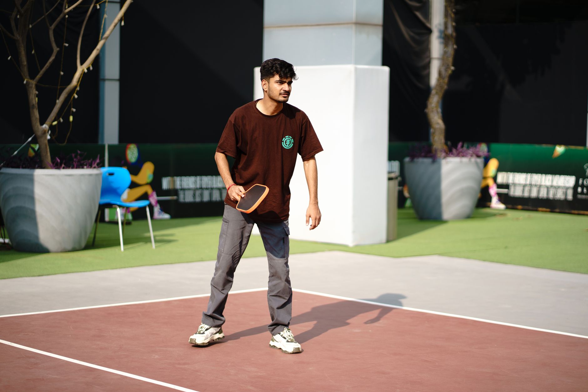 Player hitting a shot during an outdoor pickleball game